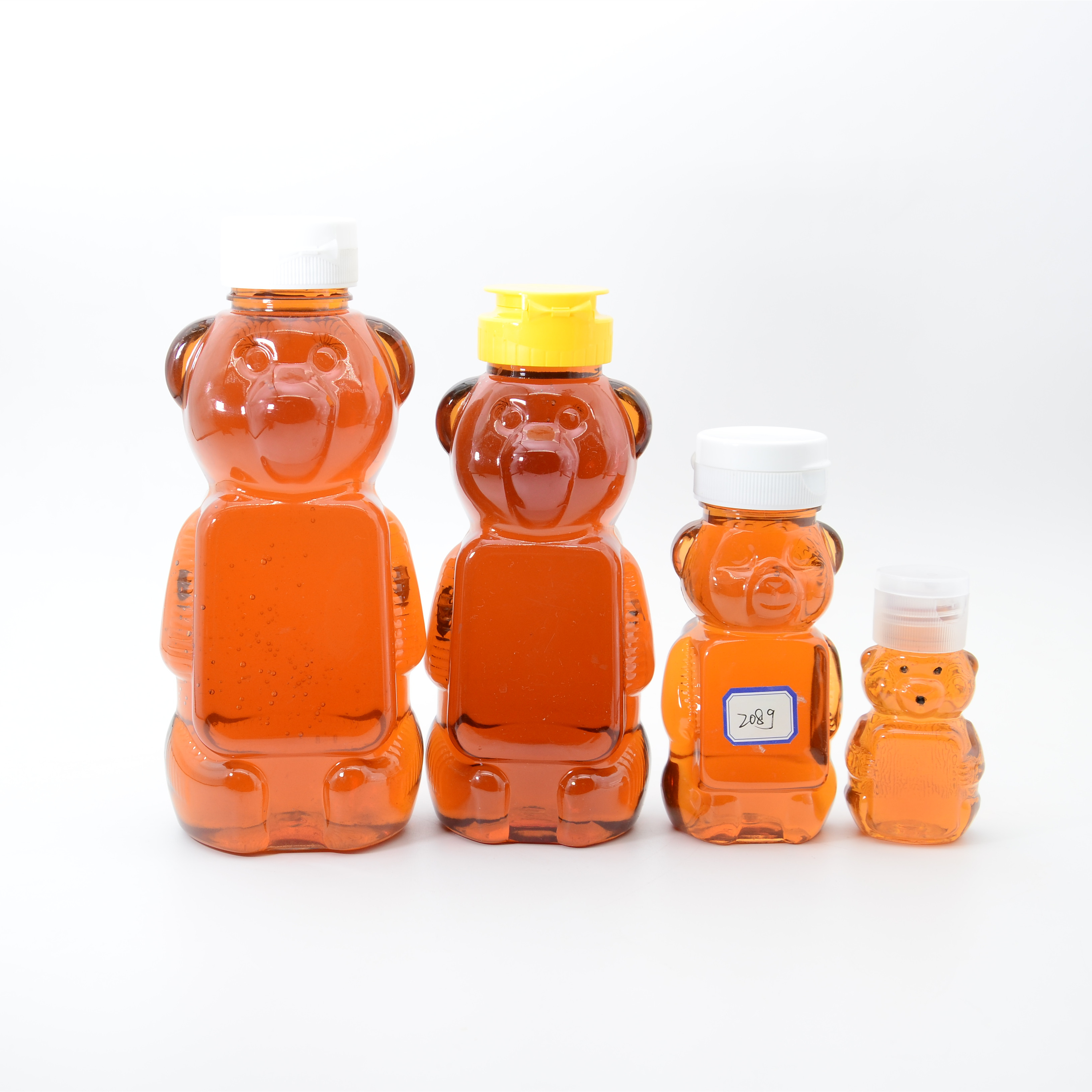Wholesale Small 2oz Honey Bear Bottles Jars Clear PET Plastic Mini Honey Bears Squeeze Bottle with Yellow Screw Top Caps